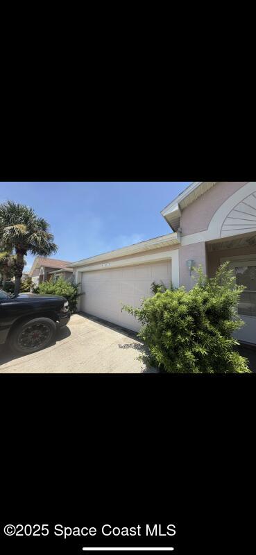 4094 Wilkes Dr, Melbourne, FL 32901 - view of front of property featuring a garage and concrete driveway