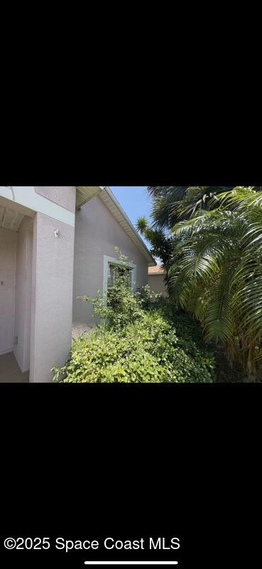 4094 Wilkes Dr, Melbourne, FL 32901 - view of side of property featuring stucco siding
