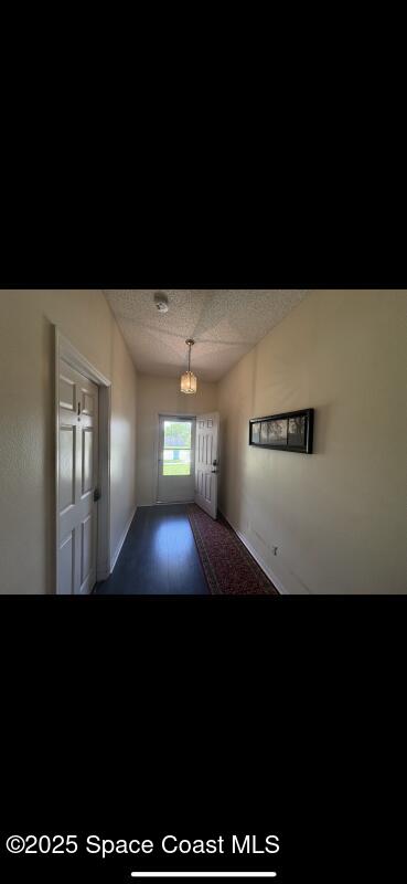 4094 Wilkes Dr, Melbourne, FL 32901 - spare room featuring a textured ceiling and baseboards
