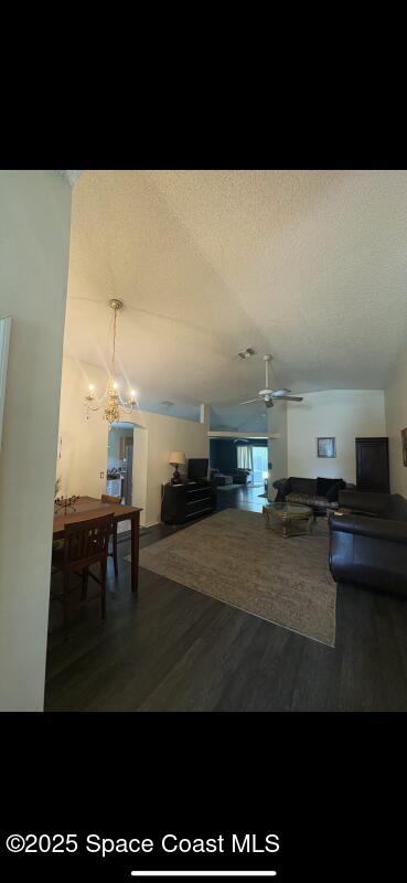 4094 Wilkes Dr, Melbourne, FL 32901 - living room featuring wood finished floors, ceiling fan, a textured ceiling, and vaulted ceiling