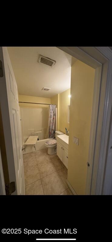 4094 Wilkes Dr, Melbourne, FL 32901 - bathroom with tile patterned floors, vanity, and shower / bathtub combination with curtain