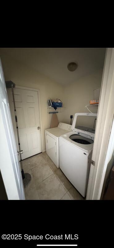 4094 Wilkes Dr, Melbourne, FL 32901 - laundry room featuring independent washer and dryer and light tile patterned floors