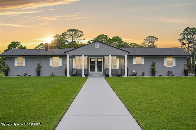 3440 Pine St, Cocoa, FL 32926 - ranch-style home featuring a front lawn, stucco siding, and french doors