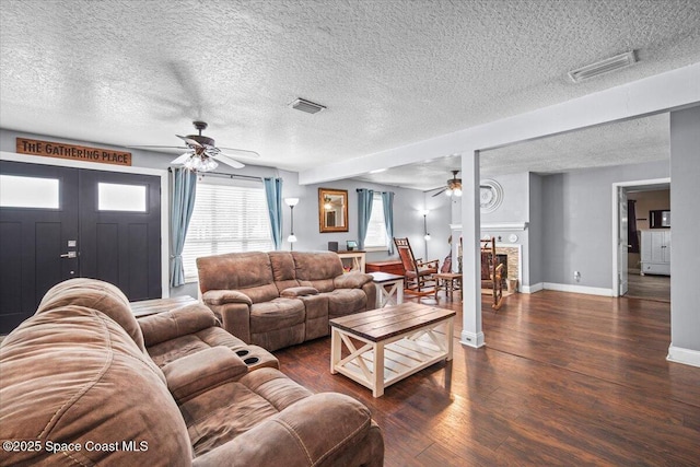 3440 Pine St, Cocoa, FL 32926 - living room featuring ceiling fan, wood finished floors, a textured ceiling, and a fireplace