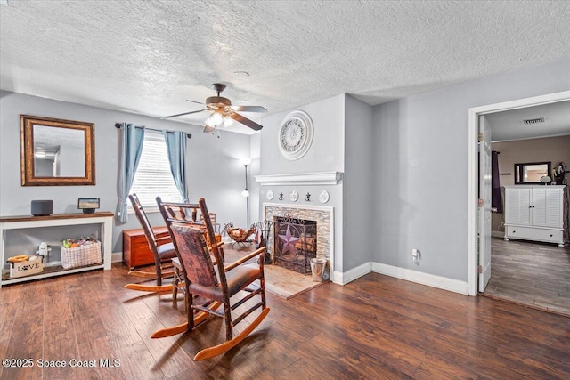 3440 Pine St, Cocoa, FL 32926 - dining room featuring wood finished floors, ceiling fan, a textured ceiling, and a fireplace