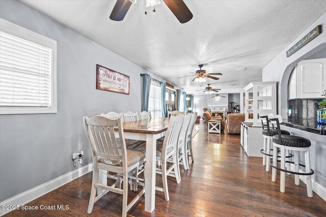 3440 Pine St, Cocoa, FL 32926 - dining space featuring a ceiling fan, dark wood finished floors, and a textured ceiling