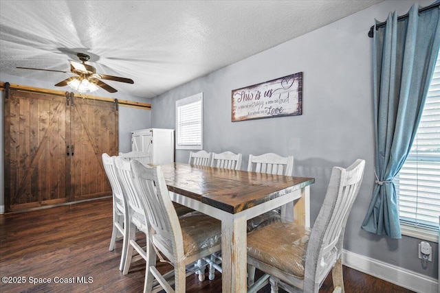 3440 Pine St, Cocoa, FL 32926 - dining room with dark wood-type flooring, a barn door, a ceiling fan, and a textured ceiling
