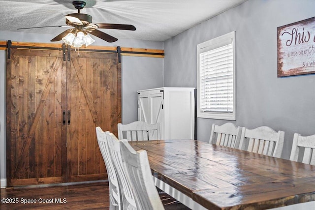 3440 Pine St, Cocoa, FL 32926 - dining space with a barn door, wood finished floors, and a ceiling fan