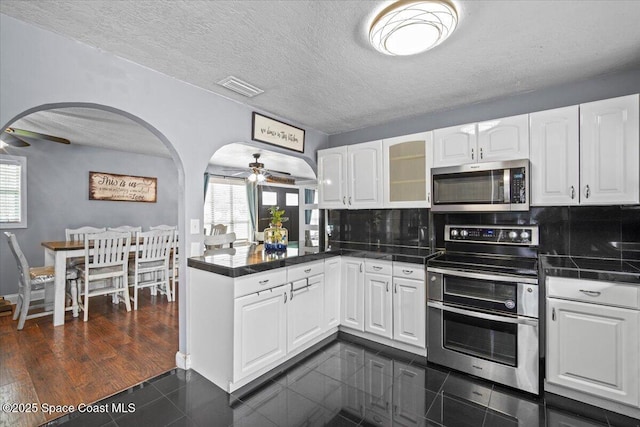 3440 Pine St, Cocoa, FL 32926 - kitchen featuring appliances with stainless steel finishes, ceiling fan, a peninsula, plenty of natural light, and a textured ceiling