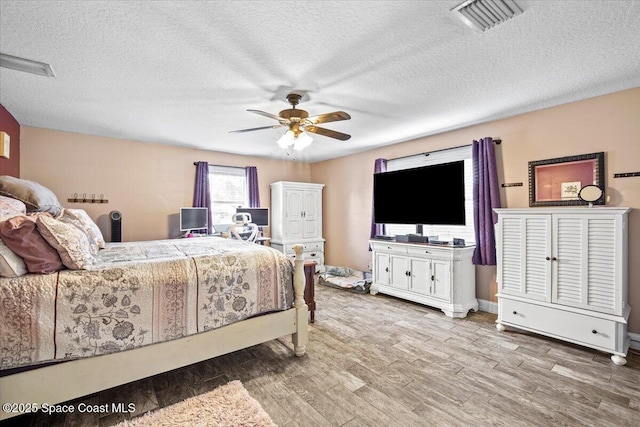 3440 Pine St, Cocoa, FL 32926 - bedroom featuring wood finished floors, a textured ceiling, and a ceiling fan