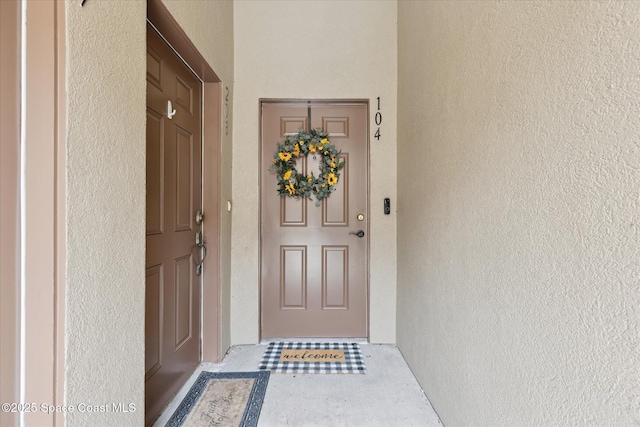 4107 Meander Pl Unit 104, Rockledge, FL 32955 - view of exterior entry featuring stucco siding