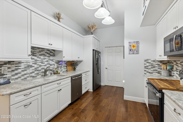 4107 Meander Pl Unit 104, Rockledge, FL 32955 - kitchen with appliances with stainless steel finishes, backsplash, white cabinets, and dark wood-style flooring