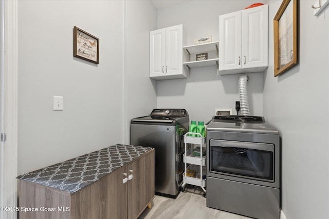 4107 Meander Pl Unit 104, Rockledge, FL 32955 - laundry area with cabinet space, washing machine and dryer, and light wood finished floors