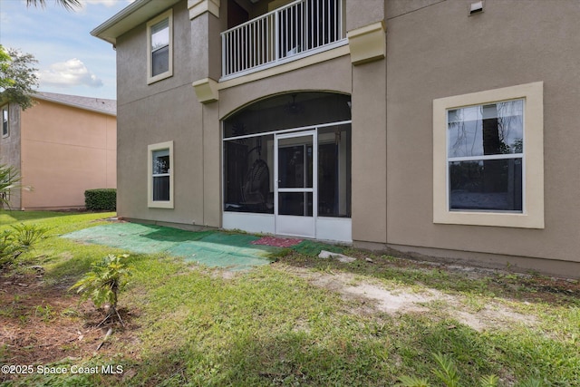 4107 Meander Pl Unit 104, Rockledge, FL 32955 - back of house with stucco siding, a lawn, and a balcony