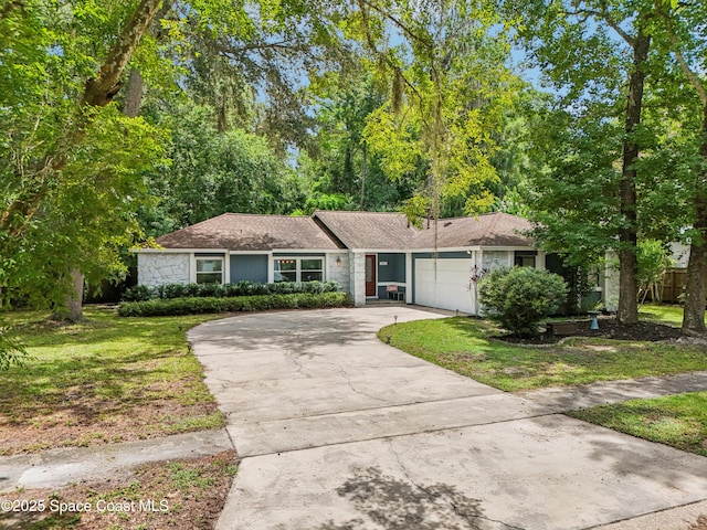 227 Holiday Ln, Winter Springs, FL 32708 - view of front of home featuring a garage, concrete driveway, a front lawn, and a shingled roof