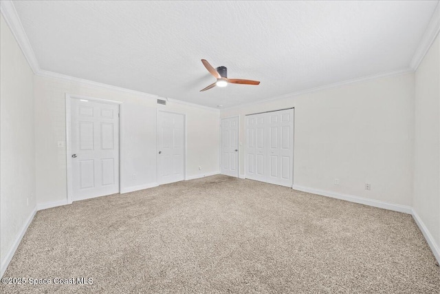 2190 Forest Knoll Dr NE Unit 90-104, Palm Bay, FL 32905 - unfurnished bedroom with carpet floors, multiple closets, ornamental molding, and a ceiling fan