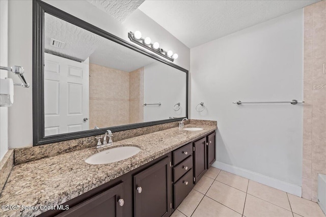 2190 Forest Knoll Dr NE Unit 90-104, Palm Bay, FL 32905 - bathroom with double vanity, tile patterned floors, a textured ceiling, and a tub
