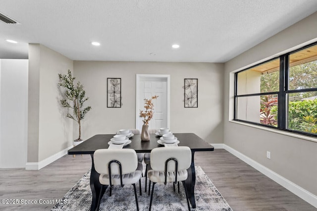 532 Buckingham Ave, Melbourne, FL 32935 - dining space with recessed lighting, wood finished floors, and a textured ceiling