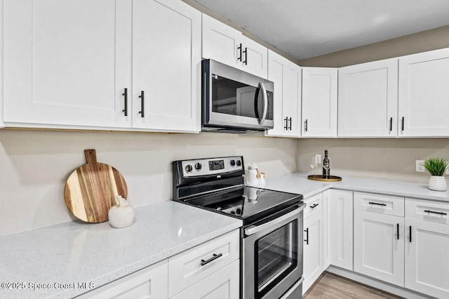 532 Buckingham Ave, Melbourne, FL 32935 - kitchen featuring appliances with stainless steel finishes, white cabinetry, and light stone counters