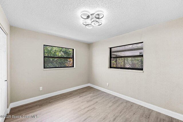 532 Buckingham Ave, Melbourne, FL 32935 - unfurnished room with plenty of natural light, a textured ceiling, and wood finished floors