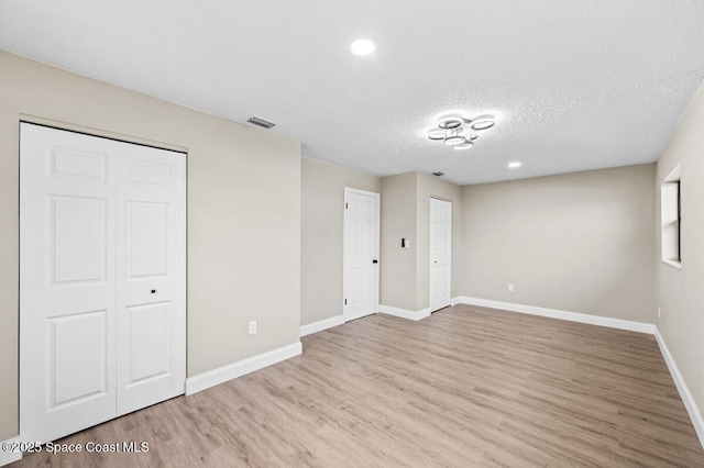 532 Buckingham Ave, Melbourne, FL 32935 - unfurnished bedroom featuring wood finished floors, a textured ceiling, and recessed lighting