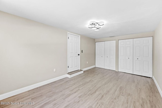 532 Buckingham Ave, Melbourne, FL 32935 - unfurnished bedroom featuring wood finished floors and multiple closets