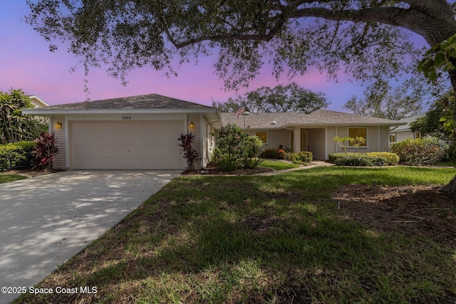 1570 Frontier Dr, Melbourne, FL 32940 - ranch-style home with an attached garage, concrete driveway, and a front yard
