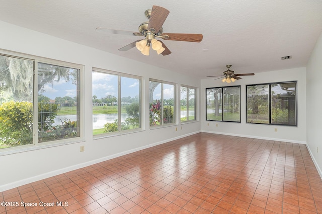 1570 Frontier Dr, Melbourne, FL 32940 - unfurnished sunroom featuring a textured ceiling, tile patterned floors, and a water view