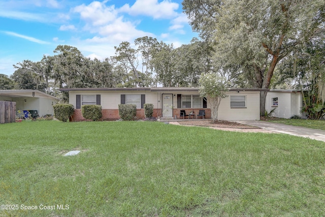 1032 Bernice Rd, Rockledge, FL 32955 - ranch-style home with a porch, brick siding, and a front yard
