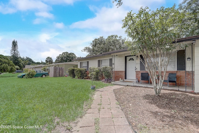 1032 Bernice Rd, Rockledge, FL 32955 - view of front of property with brick siding, a front yard, and covered porch