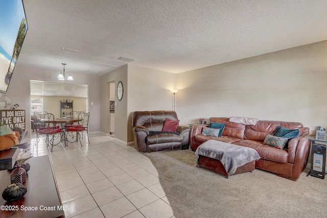 1032 Bernice Rd, Rockledge, FL 32955 - living room with light tile patterned floors, a chandelier, a textured ceiling, and light carpet