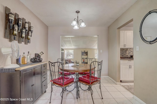 1032 Bernice Rd, Rockledge, FL 32955 - dining area with light tile patterned floors and a chandelier