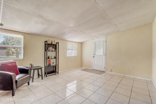 1032 Bernice Rd, Rockledge, FL 32955 - sitting room with light tile patterned floors and a drop ceiling