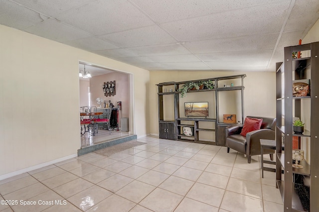 1032 Bernice Rd, Rockledge, FL 32955 - sitting room with light tile patterned flooring, a paneled ceiling, and a chandelier