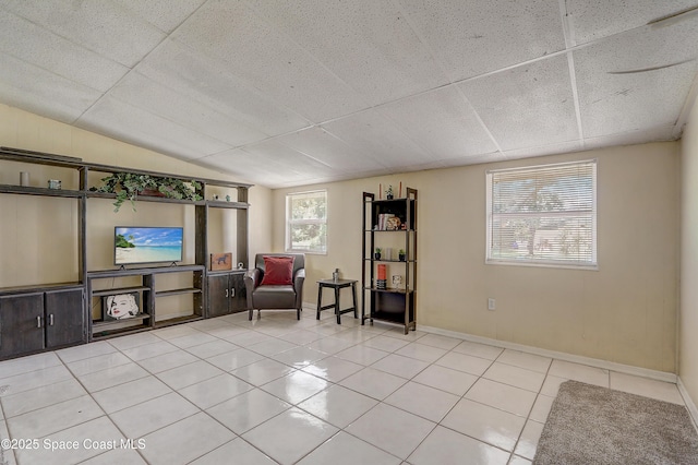 1032 Bernice Rd, Rockledge, FL 32955 - living area featuring light tile patterned floors and vaulted ceiling
