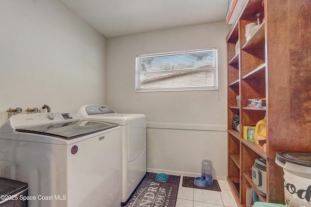 1032 Bernice Rd, Rockledge, FL 32955 - laundry room with washing machine and clothes dryer and light tile patterned flooring