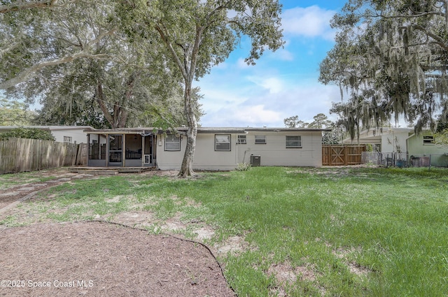 1032 Bernice Rd, Rockledge, FL 32955 - back of property featuring a sunroom and a fenced backyard