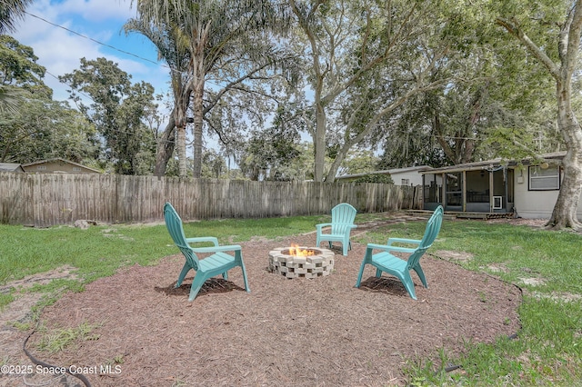 1032 Bernice Rd, Rockledge, FL 32955 - fenced backyard featuring a fire pit and a sunroom