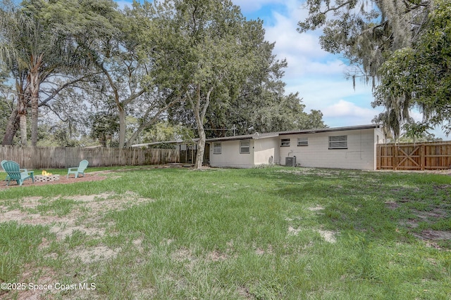 1032 Bernice Rd, Rockledge, FL 32955 - fenced backyard with an outdoor fire pit