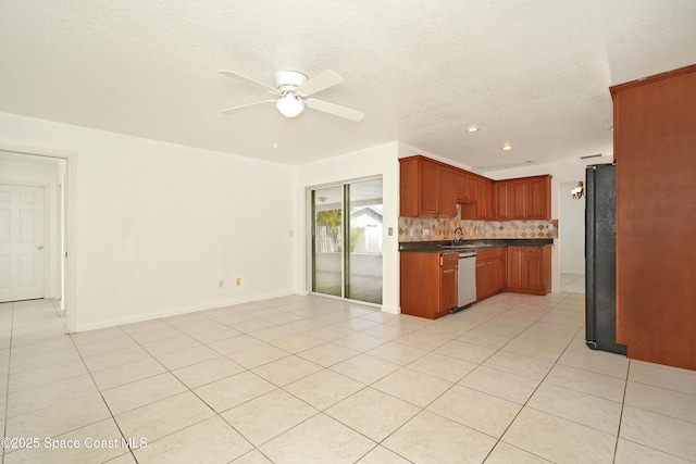 765 Palm Dr, Satellite Beach, FL 32937 - kitchen with dishwasher, freestanding refrigerator, ceiling fan, open floor plan, and dark countertops