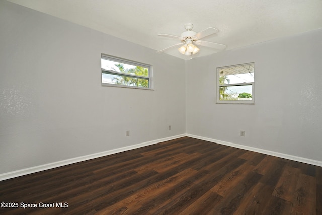 765 Palm Dr, Satellite Beach, FL 32937 - empty room featuring plenty of natural light, dark wood-style floors, and a ceiling fan