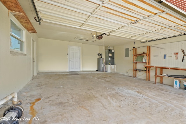 765 Palm Dr, Satellite Beach, FL 32937 - garage with a garage door opener, water heater, heating unit, electric panel, and a workshop area