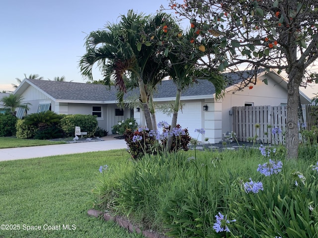 658 Hibiscus Dr, Satellite Beach, FL 32937 - ranch-style home with an attached garage, roof with shingles, and driveway