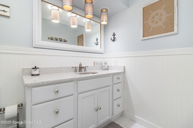 658 Hibiscus Dr, Satellite Beach, FL 32937 - bathroom featuring vanity, a wainscoted wall, and tile patterned floors