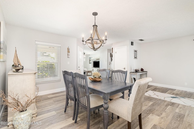 658 Hibiscus Dr, Satellite Beach, FL 32937 - dining area featuring a chandelier and light wood finished floors