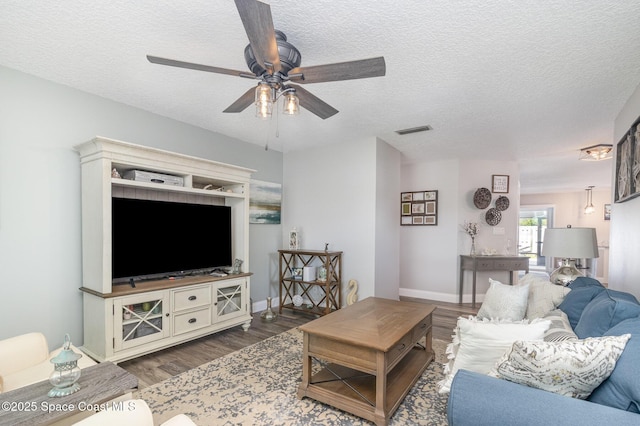658 Hibiscus Dr, Satellite Beach, FL 32937 - living room featuring a ceiling fan, wood finished floors, and a textured ceiling