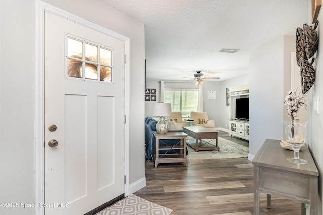 658 Hibiscus Dr, Satellite Beach, FL 32937 - entryway with dark wood-style flooring, a ceiling fan, and a textured ceiling