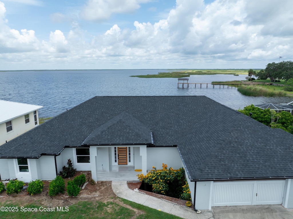 855 Cliftons Cove Ct, Cocoa, FL 32926 - view of front facade featuring roof with shingles, a water view, and stucco siding