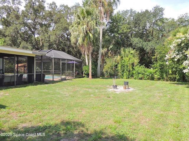 1368 Gleneagles Way, Rockledge, FL 32955 - view of grassy yard with an outdoor pool, a lanai, and view of wooded area