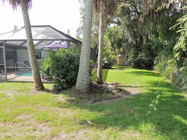 1368 Gleneagles Way, Rockledge, FL 32955 - view of grassy yard featuring a shed, an outdoor pool, and glass enclosure